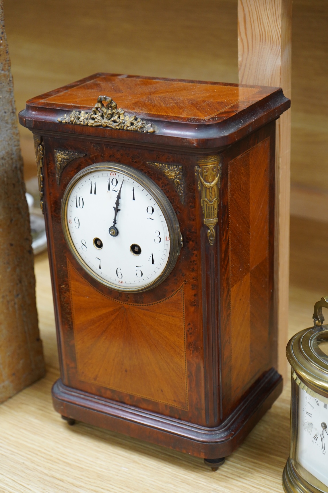 A 19th century oval brass carriage clock, striking on a bell, together with a mahogany and burr yew mantel clock, striking on a coiled gong, gong missing, largest 34cm high